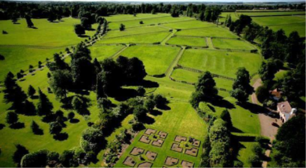 Aerial view of Newsells Park Garden with reg aural shaped grass areas trees and part of a formal garden
