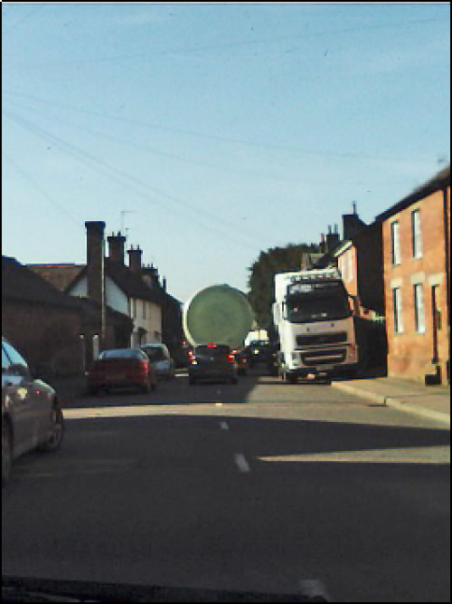 Lorry mounting pavement to let another lorry pass