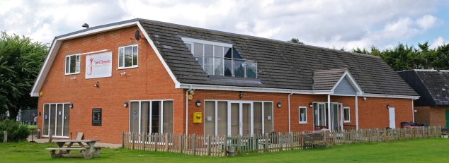 Red brick and tile with mansard roof sports and community centre