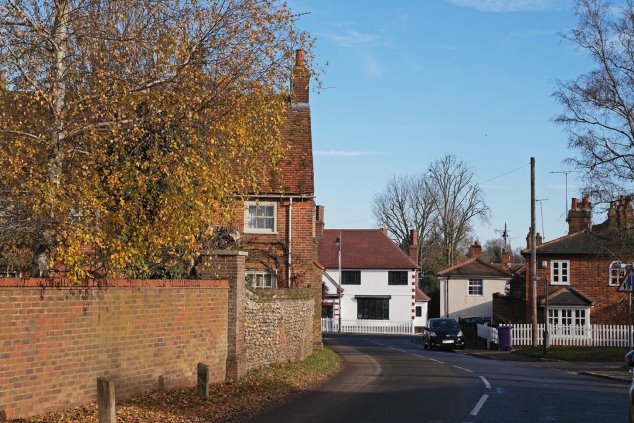 View 8 From Codicote Lodge driveway looking north east to 1/3 Heath Lane - slight bend in the road with red brick and flint walls on left - looking into the historic homes in the High street