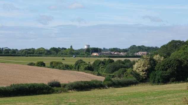 A view across fields to the sports centre and the water tower